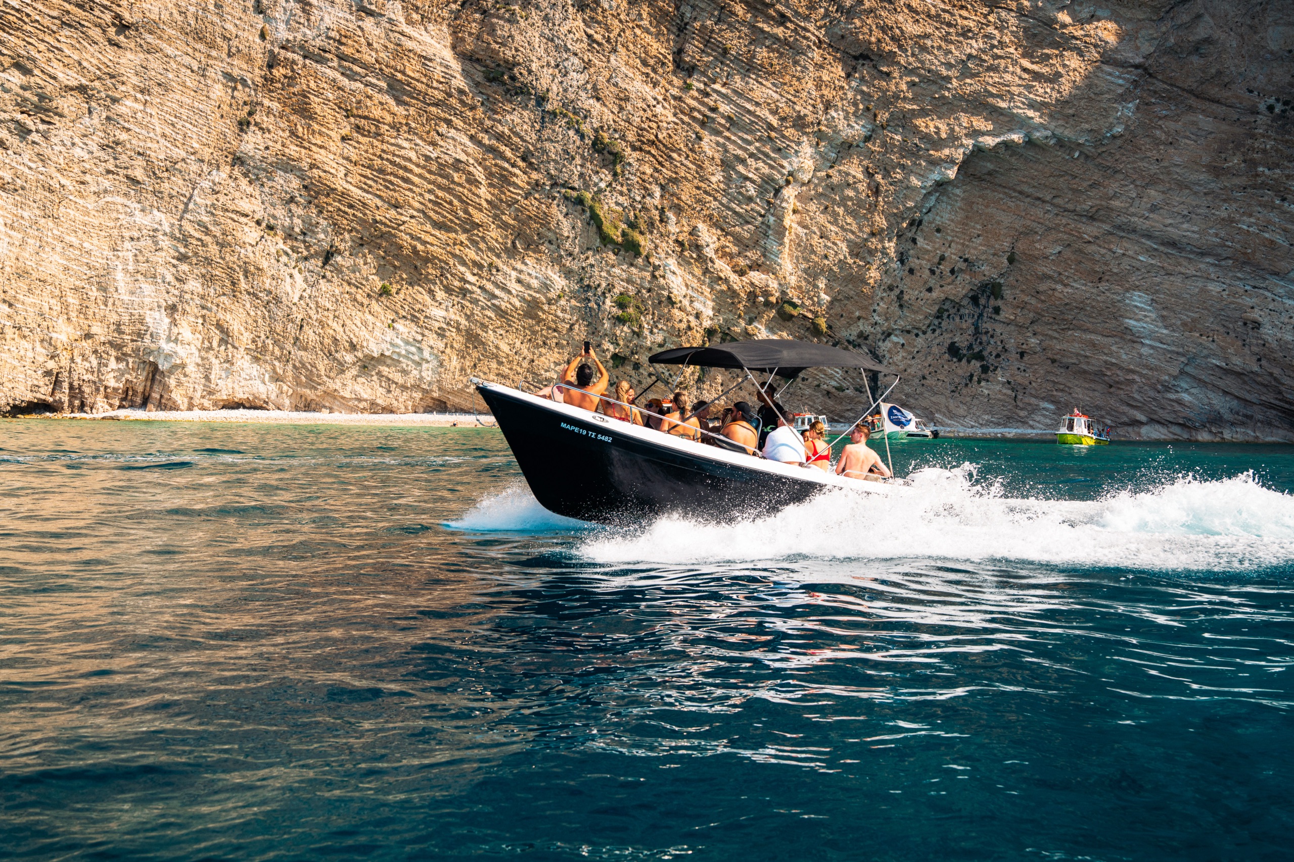 A motorboat sailing along the cliffs, photographed with a Sigma 28–105mm lens